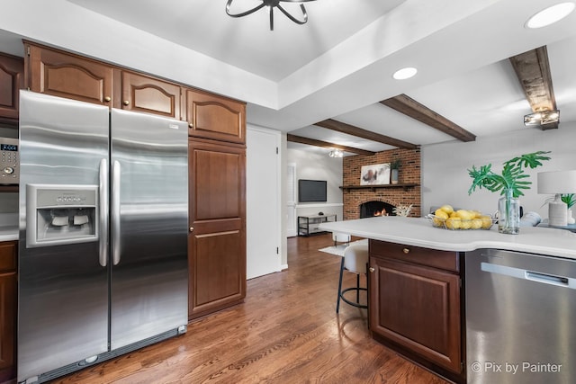 570 E Carpenter Dr, Palatine, IL 60074 - kitchen featuring appliances with stainless steel finishes, open floor plan, light countertops, dark wood-style flooring, and beam ceiling