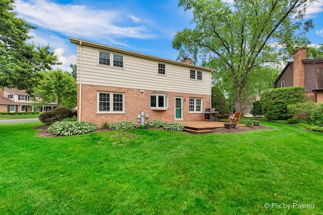 570 E Carpenter Dr, Palatine, IL 60074 - rear view of house with brick siding, a wooden deck, a lawn, and a chimney