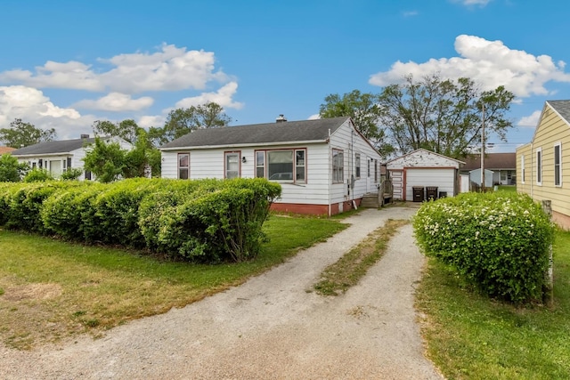 view of front of home featuring a garage, an outbuilding, dirt driveway, and a chimney