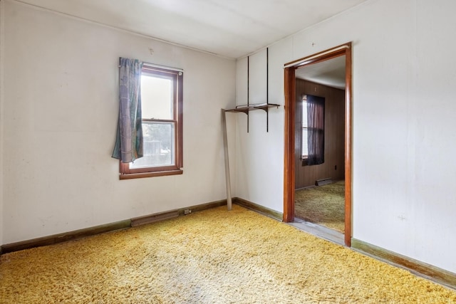 carpeted spare room with baseboards