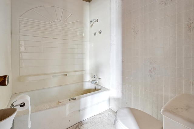 full bathroom with toilet, washtub / shower combination, and tile walls