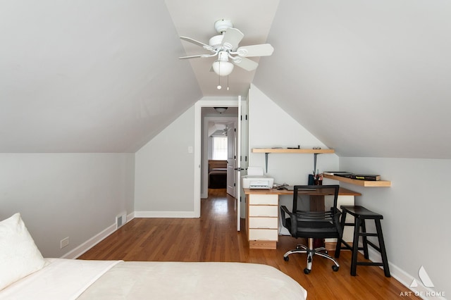 office area featuring wood finished floors, a ceiling fan, baseboards, and vaulted ceiling