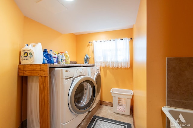 washroom with washer and clothes dryer and tile patterned floors