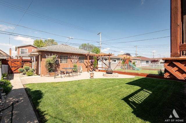 view of yard with a patio, a gate, and a playground