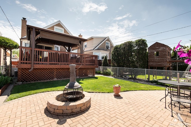 view of patio featuring a fire pit and a deck