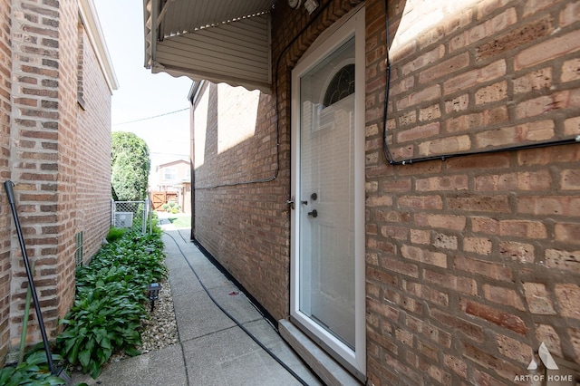 property entrance featuring brick siding