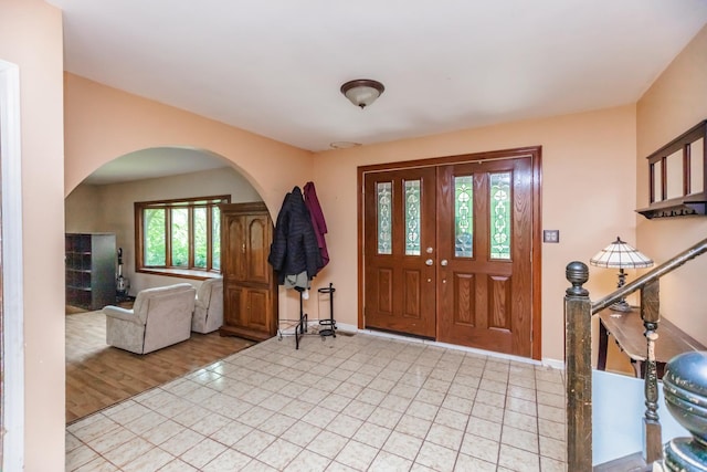 5N683 Ravine Dr, Saint Charles, IL 60175 - entryway featuring arched walkways, baseboards, and light tile patterned floors