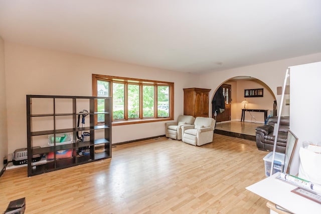 5N683 Ravine Dr, Saint Charles, IL 60175 - living room featuring arched walkways, light wood-type flooring, and baseboards