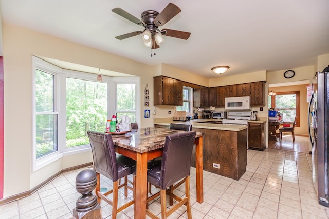 5N683 Ravine Dr, Saint Charles, IL 60175 - dining room featuring light tile patterned flooring, a ceiling fan, and baseboards