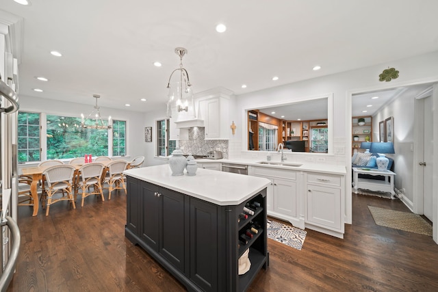 1305 Sleepy Hollow Rd, Glenview, IL 60025 - kitchen featuring a sink, white cabinets, light countertops, dark cabinets, and backsplash