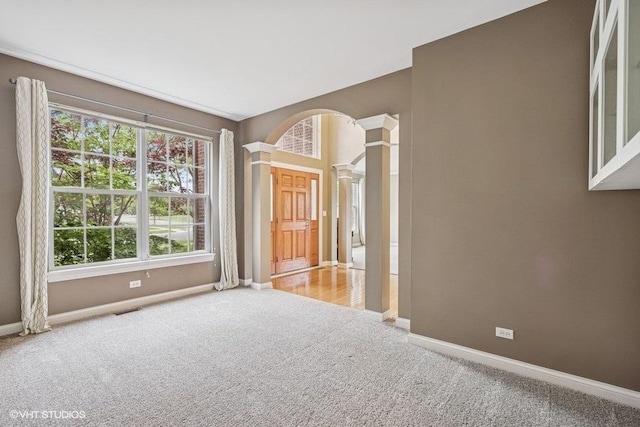 218 Bridle Path Ln, Fox River Grove, IL 60021 - carpeted spare room featuring decorative columns and baseboards