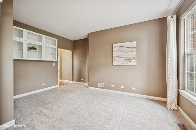 218 Bridle Path Ln, Fox River Grove, IL 60021 - carpeted spare room featuring baseboards and plenty of natural light