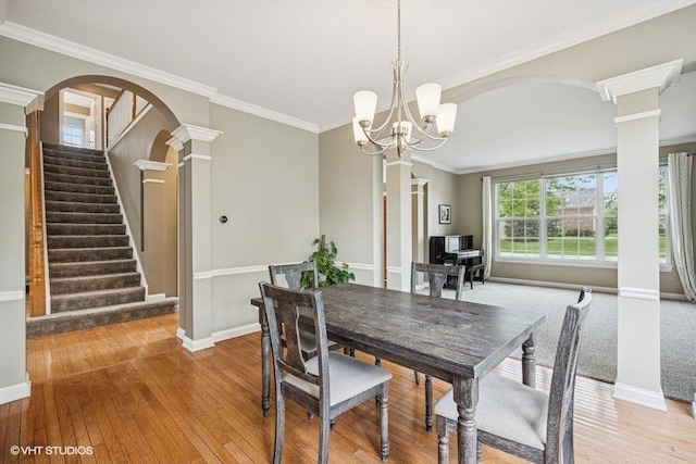 218 Bridle Path Ln, Fox River Grove, IL 60021 - dining area featuring ornate columns, light wood-style flooring, baseboards, stairs, and a chandelier