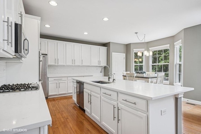218 Bridle Path Ln, Fox River Grove, IL 60021 - kitchen with a sink, appliances with stainless steel finishes, tasteful backsplash, white cabinets, and recessed lighting