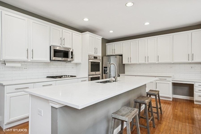 218 Bridle Path Ln, Fox River Grove, IL 60021 - kitchen featuring appliances with stainless steel finishes, a sink, white cabinets, backsplash, and recessed lighting