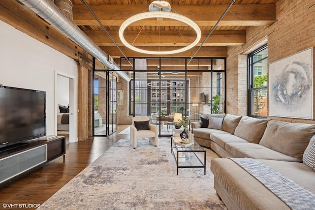 14 N Peoria St Unit 3E, Chicago, IL 60607 - living area featuring wood ceiling with exposed beams, wood finished floors, brick wall, and a high ceiling