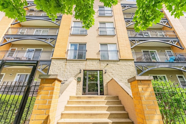 view of apartment building / complex featuring fence