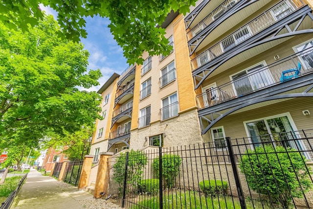 view of apartment building / complex with fence
