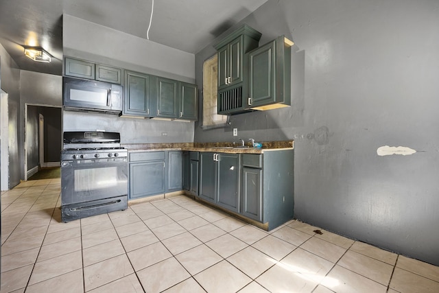 4321 W Maypole Ave, Chicago, IL 60624 - kitchen with black appliances, a sink, and light tile patterned flooring