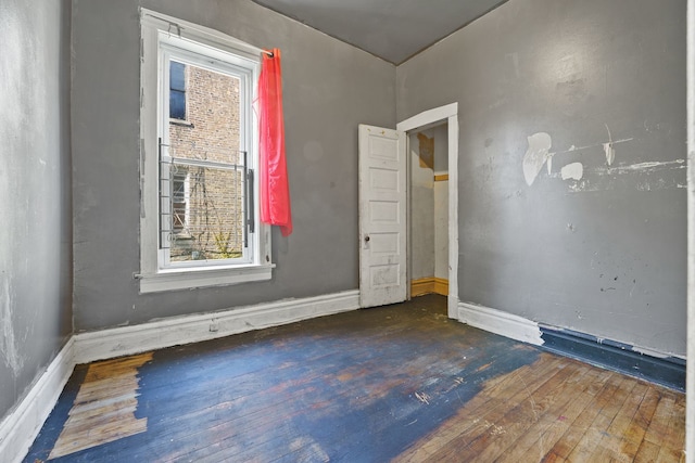 4321 W Maypole Ave, Chicago, IL 60624 - spare room featuring wood-type flooring, healthy amount of natural light, and baseboards
