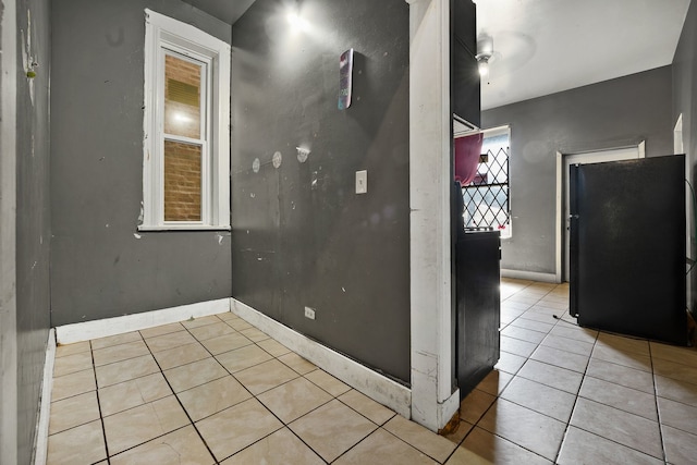 4321 W Maypole Ave, Chicago, IL 60624 - spare room with light tile patterned floors and baseboards
