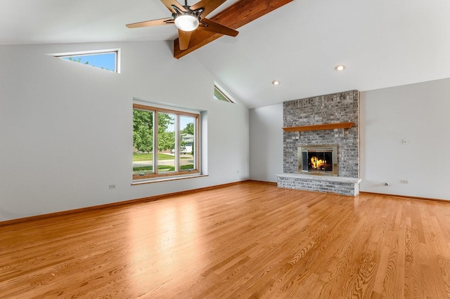 1936 Sybil Dr, Crest Hill, IL 60403 - unfurnished living room with beam ceiling, a ceiling fan, light wood-style flooring, a fireplace, and high vaulted ceiling