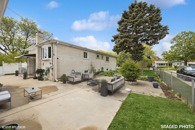 769 N Eastland St, Elmhurst, IL 60126 - back of property with a chimney, brick siding, a patio area, and an outdoor living space