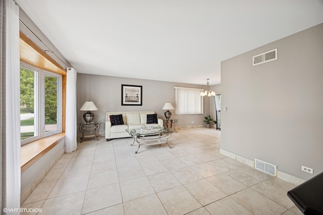 769 N Eastland St, Elmhurst, IL 60126 - living area with a chandelier, light tile patterned floors, and baseboards