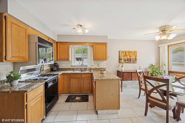 769 N Eastland St, Elmhurst, IL 60126 - kitchen featuring black gas range oven, a sink, backsplash, and healthy amount of natural light