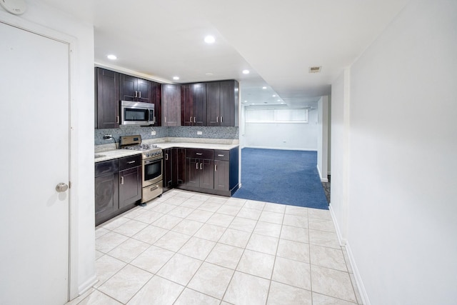 5416 N Neva Ave, Chicago, IL 60656 - kitchen with stainless steel appliances, light countertops, dark brown cabinetry, tasteful backsplash, and recessed lighting