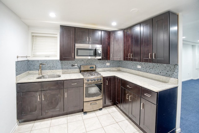 5416 N Neva Ave, Chicago, IL 60656 - kitchen with stainless steel appliances, a sink, decorative backsplash, dark brown cabinetry, and recessed lighting
