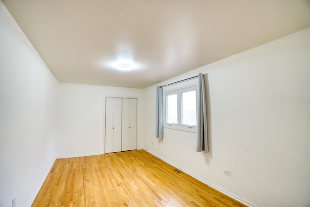 5416 N Neva Ave, Chicago, IL 60656 - unfurnished bedroom with light wood-style floors, baseboards, and a closet