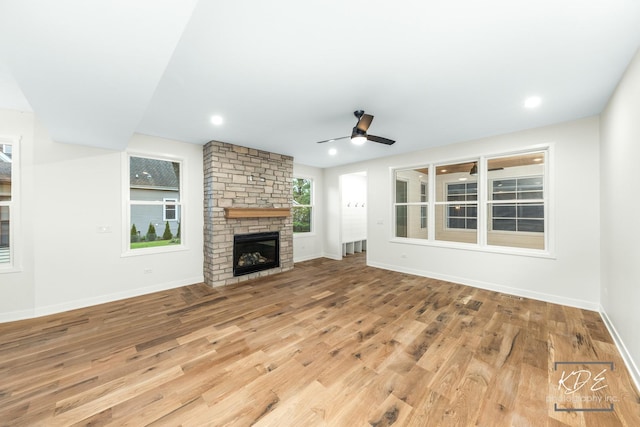 715 N Brainard St, Naperville, IL 60563 - unfurnished living room with wood finished floors, a stone fireplace, ceiling fan, and recessed lighting