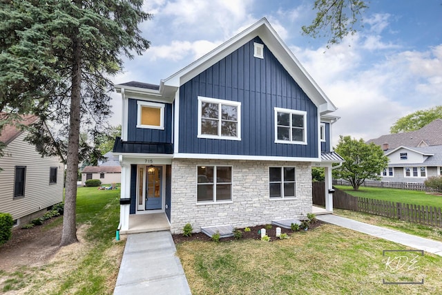 715 N Brainard St, Naperville, IL 60563 - view of front facade with board and batten siding, stone siding, and a standing seam roof