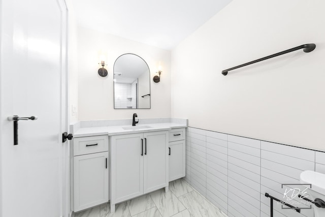 715 N Brainard St, Naperville, IL 60563 - bathroom with marble look tiles, vanity, and tile walls