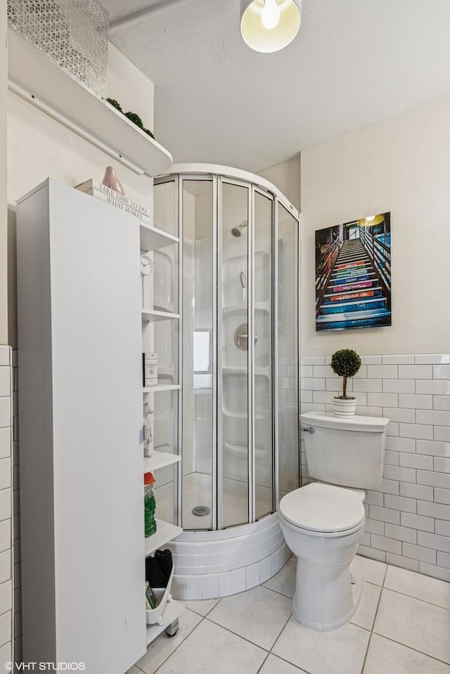 5415 N Sheridan Rd Unit 5011, Chicago, IL 60640 - full bathroom with tile patterned floors, a shower stall, toilet, and tile walls
