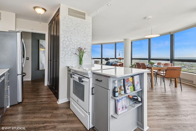5415 N Sheridan Rd Unit 5011, Chicago, IL 60640 - kitchen with freestanding refrigerator, electric range, a peninsula, dark wood-style floors, and light countertops