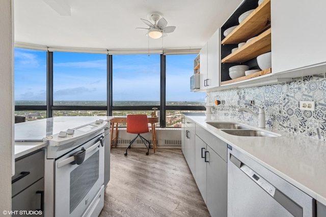 5415 N Sheridan Rd Unit 5011, Chicago, IL 60640 - kitchen with white range with electric cooktop, a sink, dishwasher, a ceiling fan, and light wood-style floors