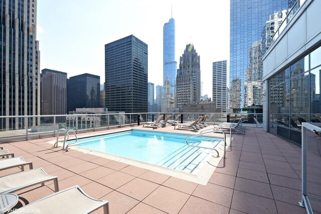 240 E Illinois St Unit 402, Chicago, IL 60611 - community pool featuring a view of skyline and a patio area