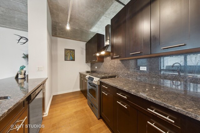 240 E Illinois St Unit 402, Chicago, IL 60611 - kitchen with stainless steel appliances, wall chimney exhaust hood, light wood-type flooring, tasteful backsplash, and dark stone countertops
