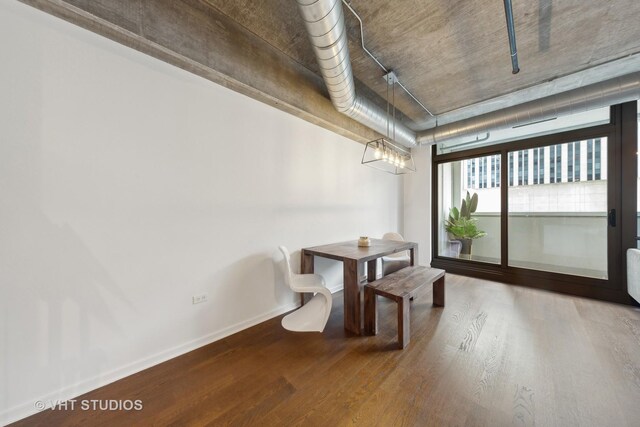 240 E Illinois St Unit 402, Chicago, IL 60611 - unfurnished dining area featuring wood finished floors, baseboards, and a chandelier