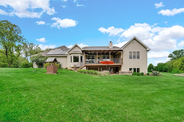 4916 Country Springs Dr, Johnsburg, IL 60051 - back of property featuring a chimney, a yard, a wooden deck, and stairway