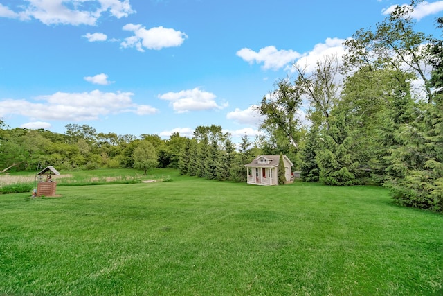 4916 Country Springs Dr, Johnsburg, IL 60051 - view of grassy yard featuring an outdoor structure and a forest view