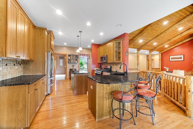 4916 Country Springs Dr, Johnsburg, IL 60051 - kitchen with stainless steel appliances, a center island, a sink, light wood-style floors, and tasteful backsplash