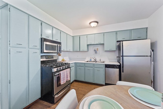 1331 S Finley Rd Unit 114, Lombard, IL 60148 - kitchen featuring stainless steel appliances, dark wood-style floors, a sink, and light countertops