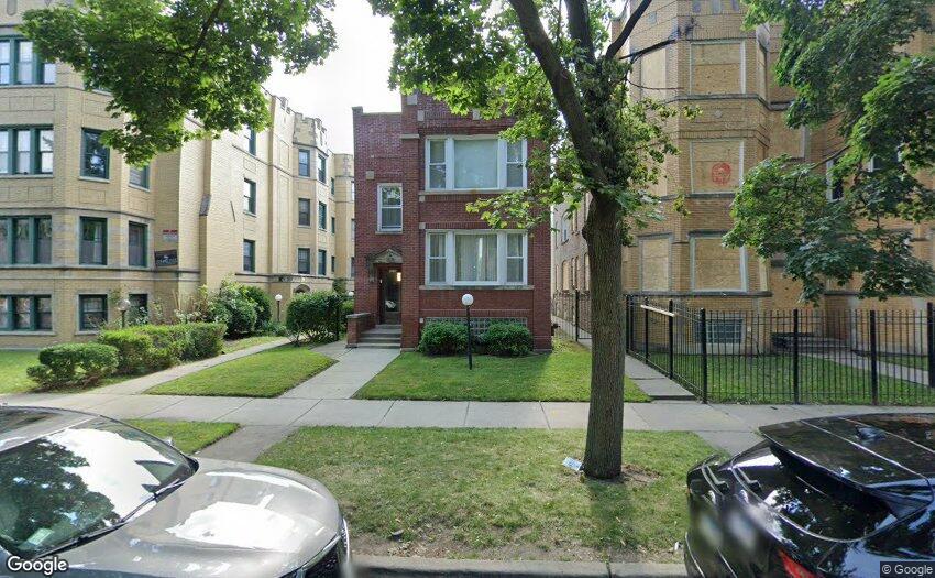 8019 S Vernon Pl, Chicago, IL 60619 - view of building exterior with fence and uncovered parking