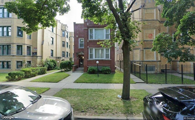 8019 S Vernon Pl, Chicago, IL 60619 - view of building exterior with fence and uncovered parking