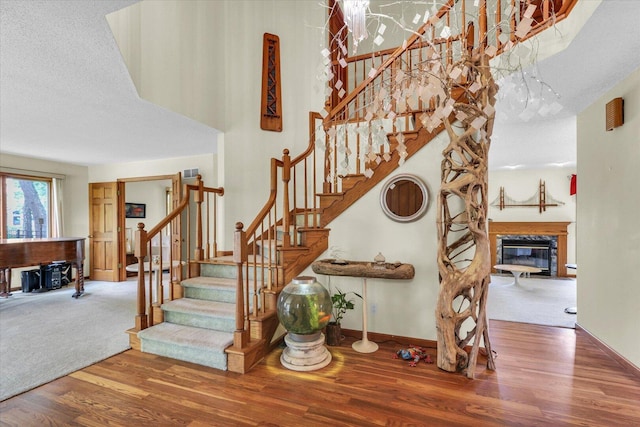 4008 Pinecrest Dr, Champaign, IL 61822 - stairway featuring wood finished floors, baseboards, and a glass covered fireplace