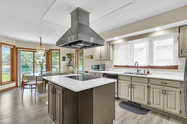 4008 Pinecrest Dr, Champaign, IL 61822 - kitchen with island range hood, a sink, black electric stovetop, stainless steel microwave, and light countertops