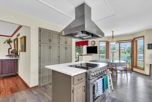 4008 Pinecrest Dr, Champaign, IL 61822 - kitchen featuring island exhaust hood, high end stainless steel range, baseboards, and wood finished floors